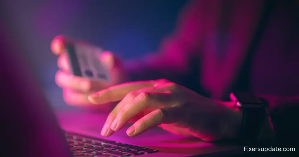 Someone is typing on a laptop, with a cheerful pink background that makes the scene lively and engaging